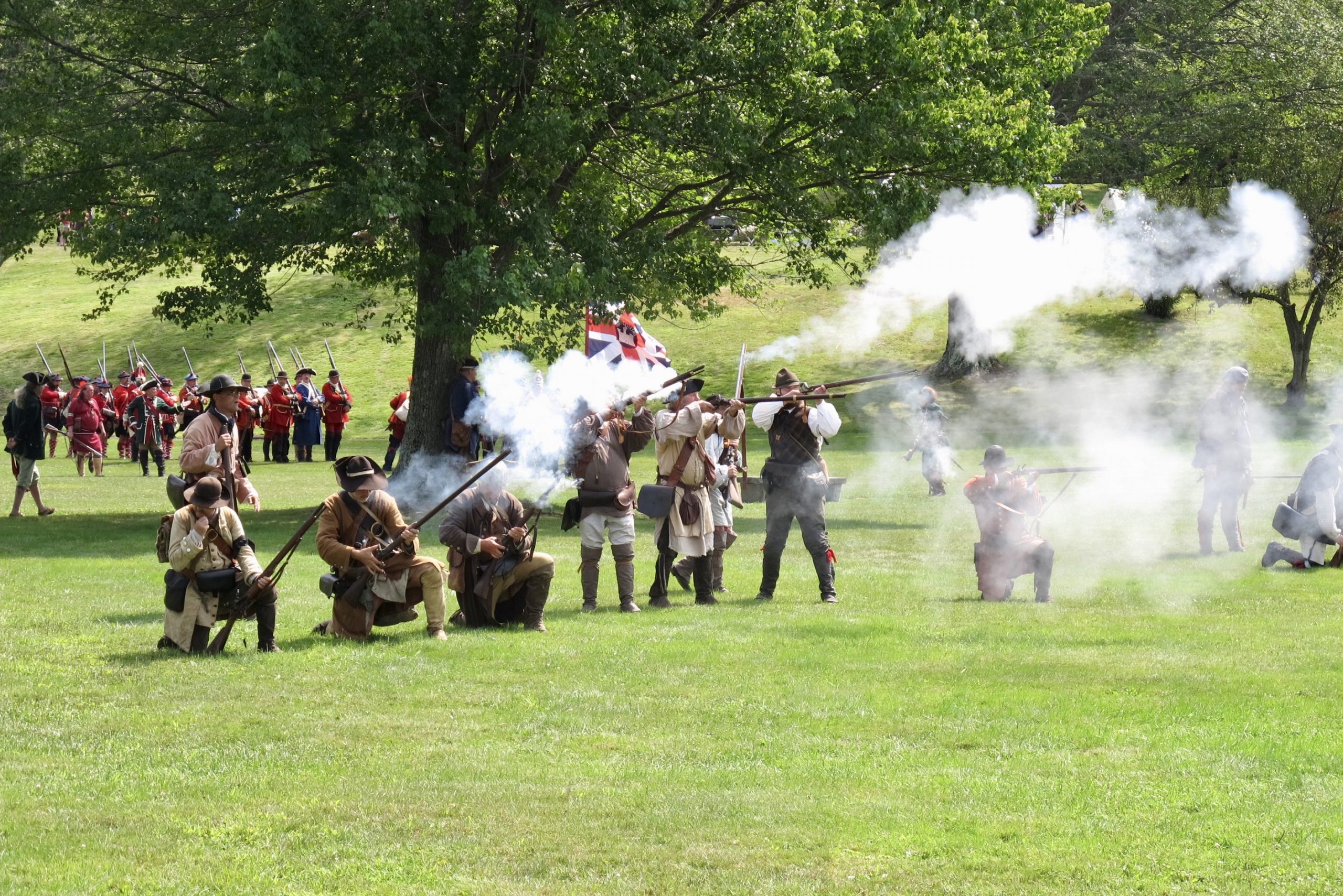 18th Century colonial soldier shoot muskets at reenactment
