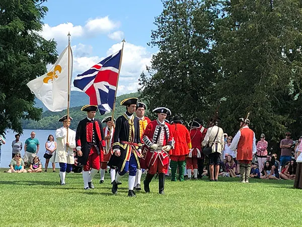 French and British soldiers marching with flags
